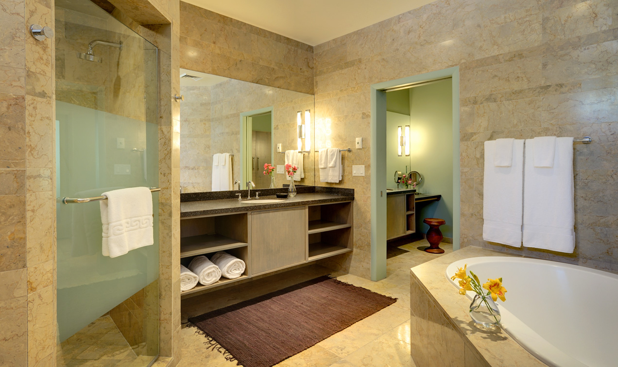 Luxurious King Suite bathroom at Desert Pearl Inn with bidet, jetted tub, walk-in shower and private vanity area
